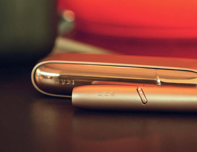 Iqos gold device on top of a table