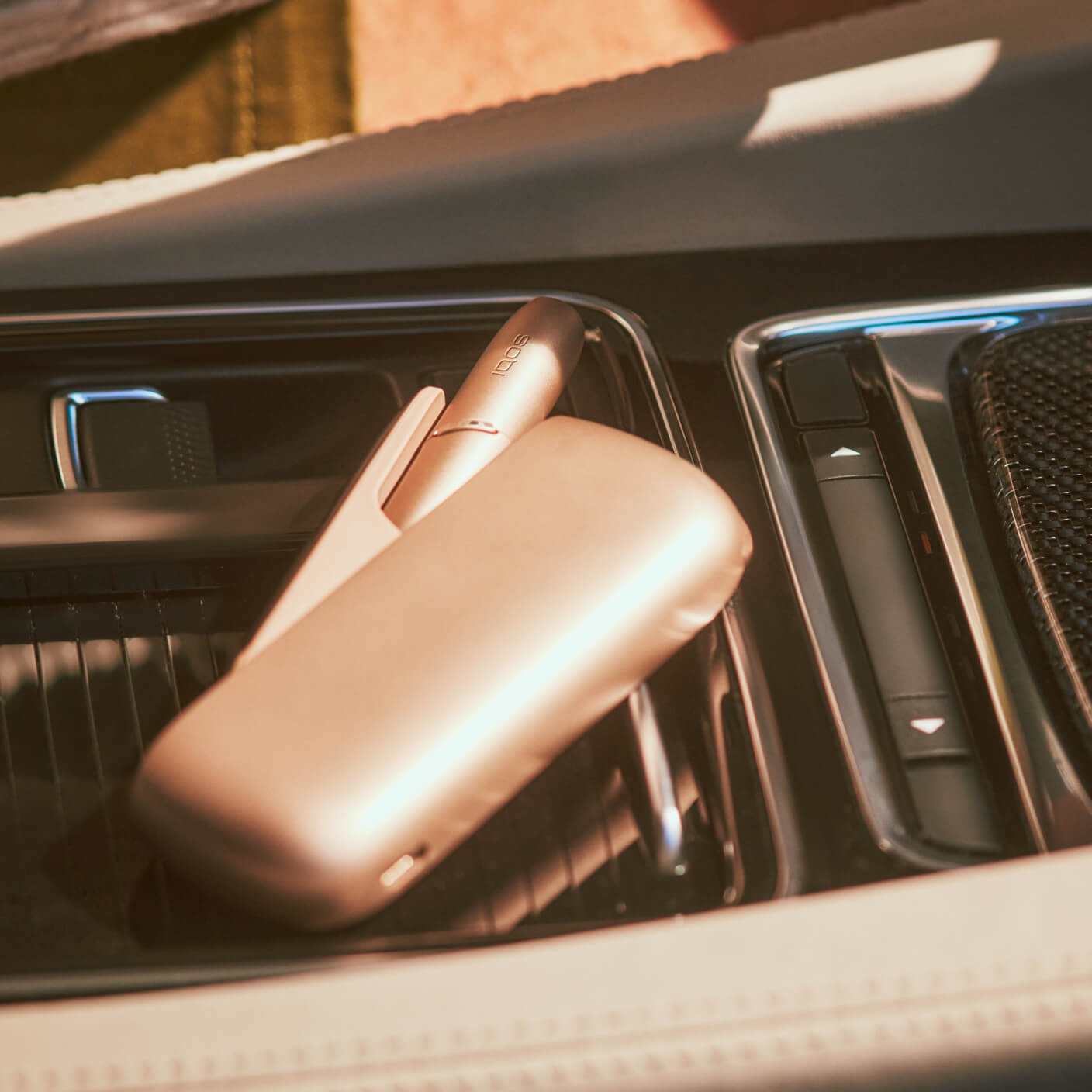 Brilliant gold IQOS 3 DUO holder inserted on fabric with red stars