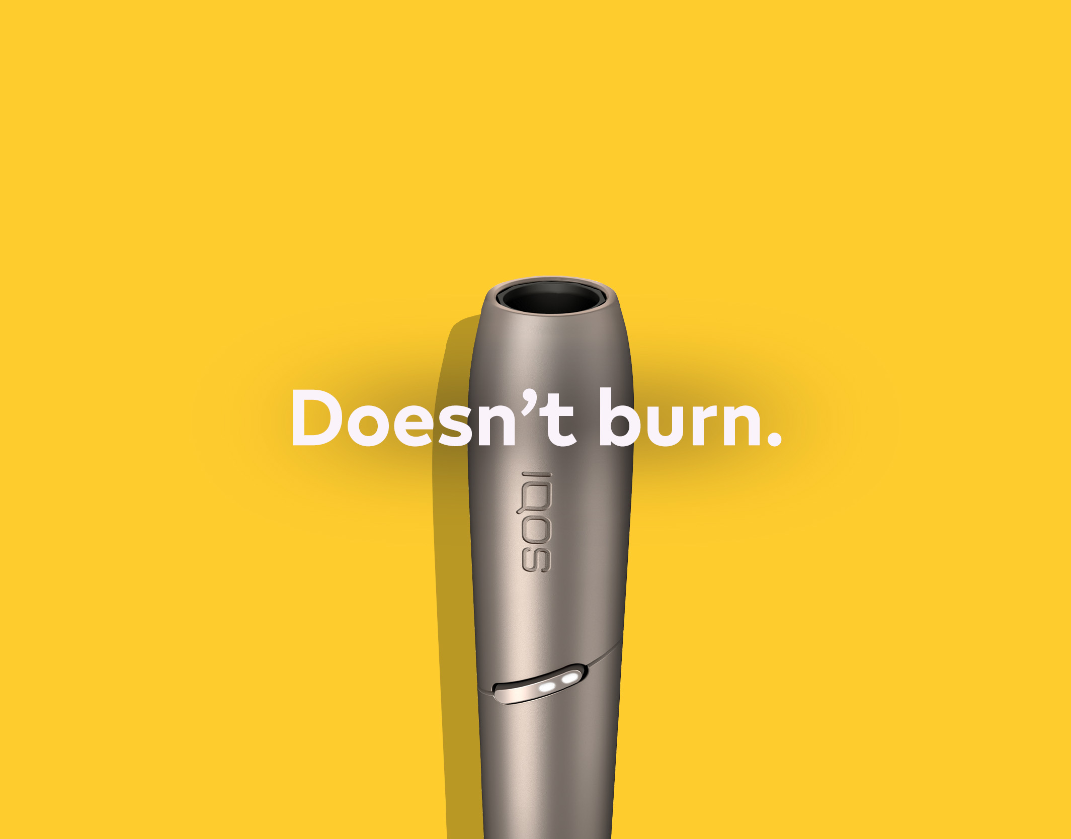 A burnt sausage on a fork and an IQOS holder.