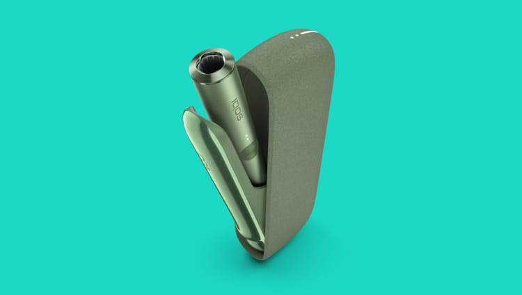 A moss green IQOS ILUMA Holder inside a Pocket Charger.