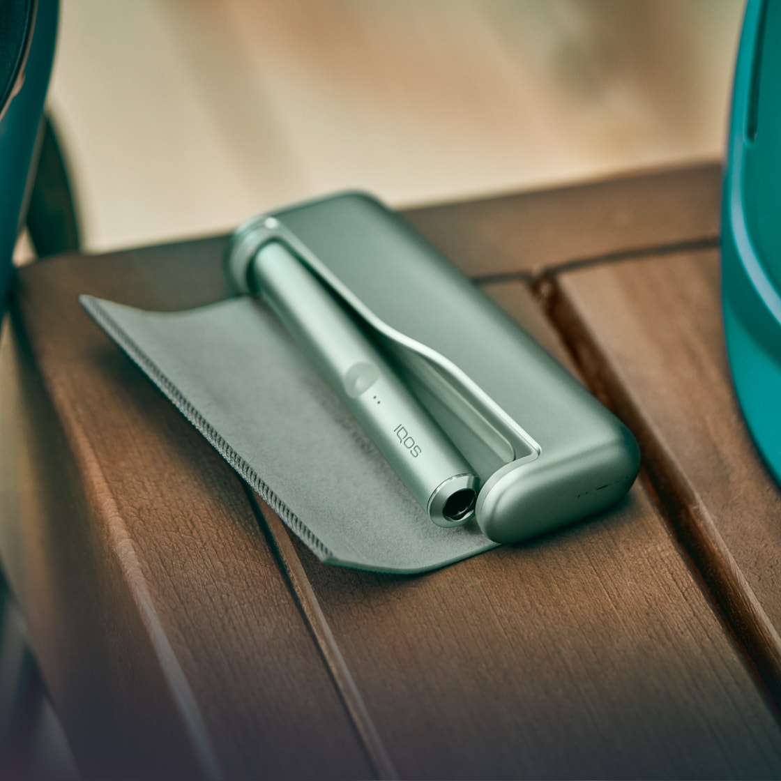 A Jade Green IQOS Pocket Charger and Holder.