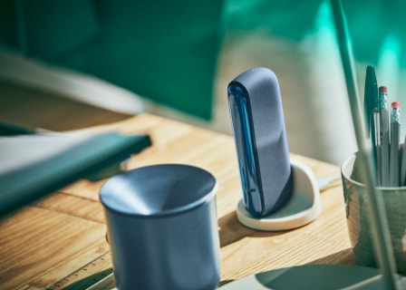 A mid azure blue IQOS ILUMA device next to a blue cup.