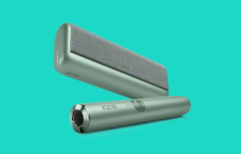 A Jade Green IQOS ILUMA LPRIME Pockete Charger and Holder.