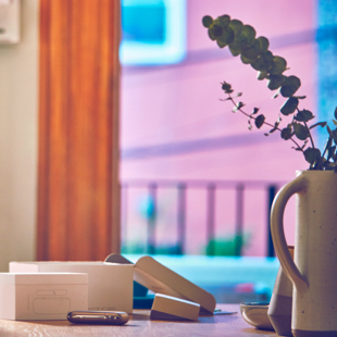 A smart phone next to an open IQOS box on a table.