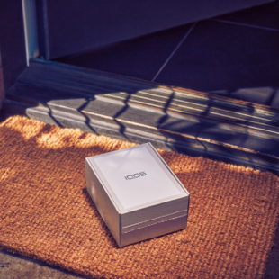 An IQOS box and IQOS Pocket Charger.