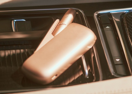 Brilliant gold IQOS 3 DUO holder and charger in a car centre panel