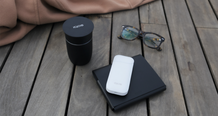 An unopened IQOS device box on a table.
