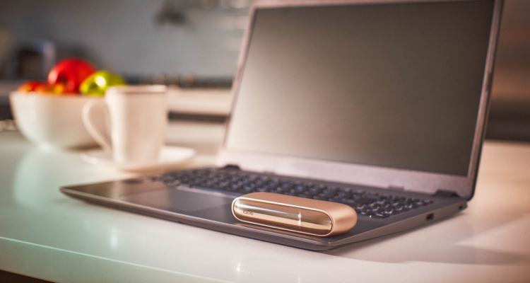 Gold IQOS DUO on a laptop