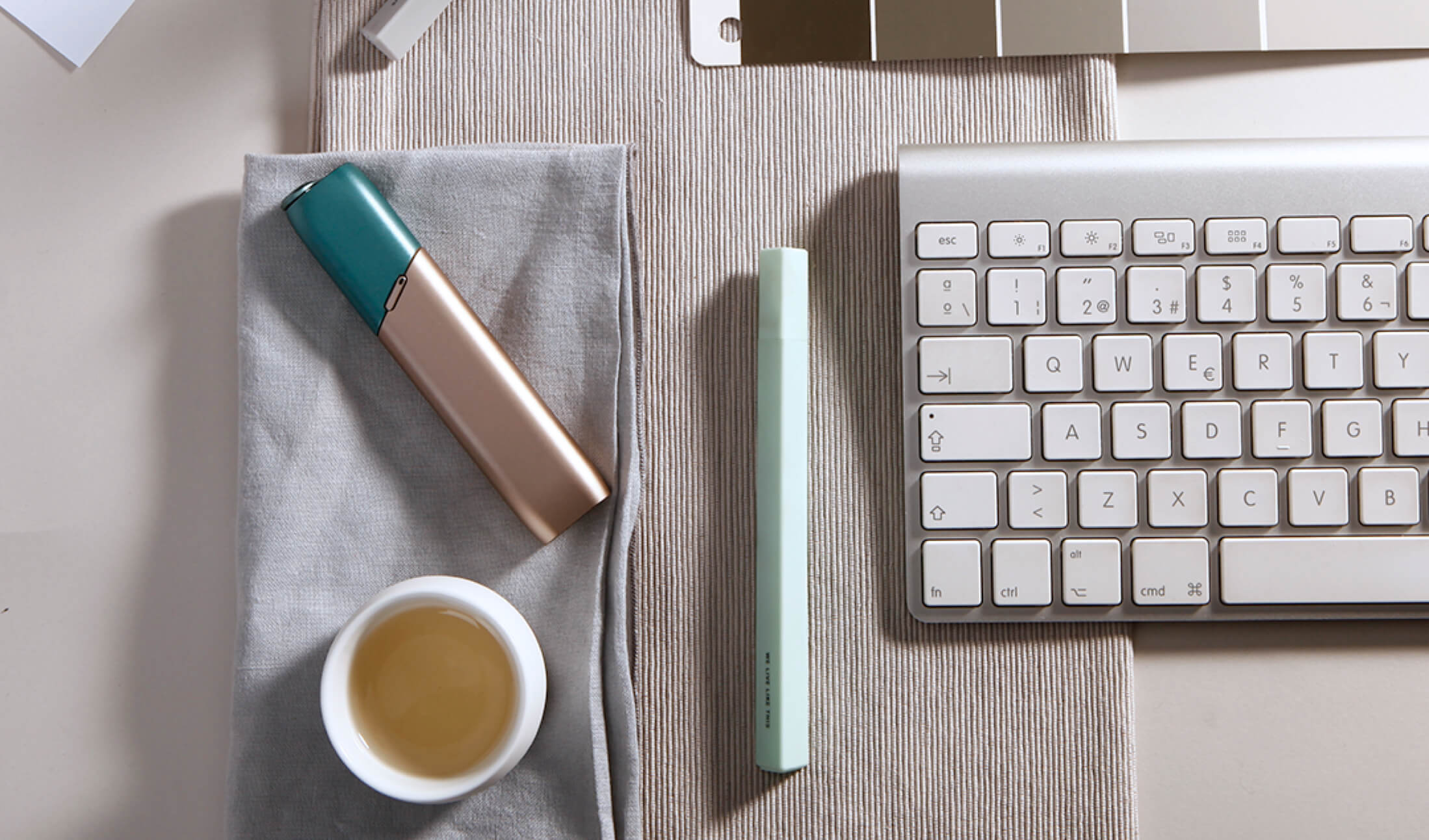 Green and coppery IQOS 3 Multi kit on a working desk