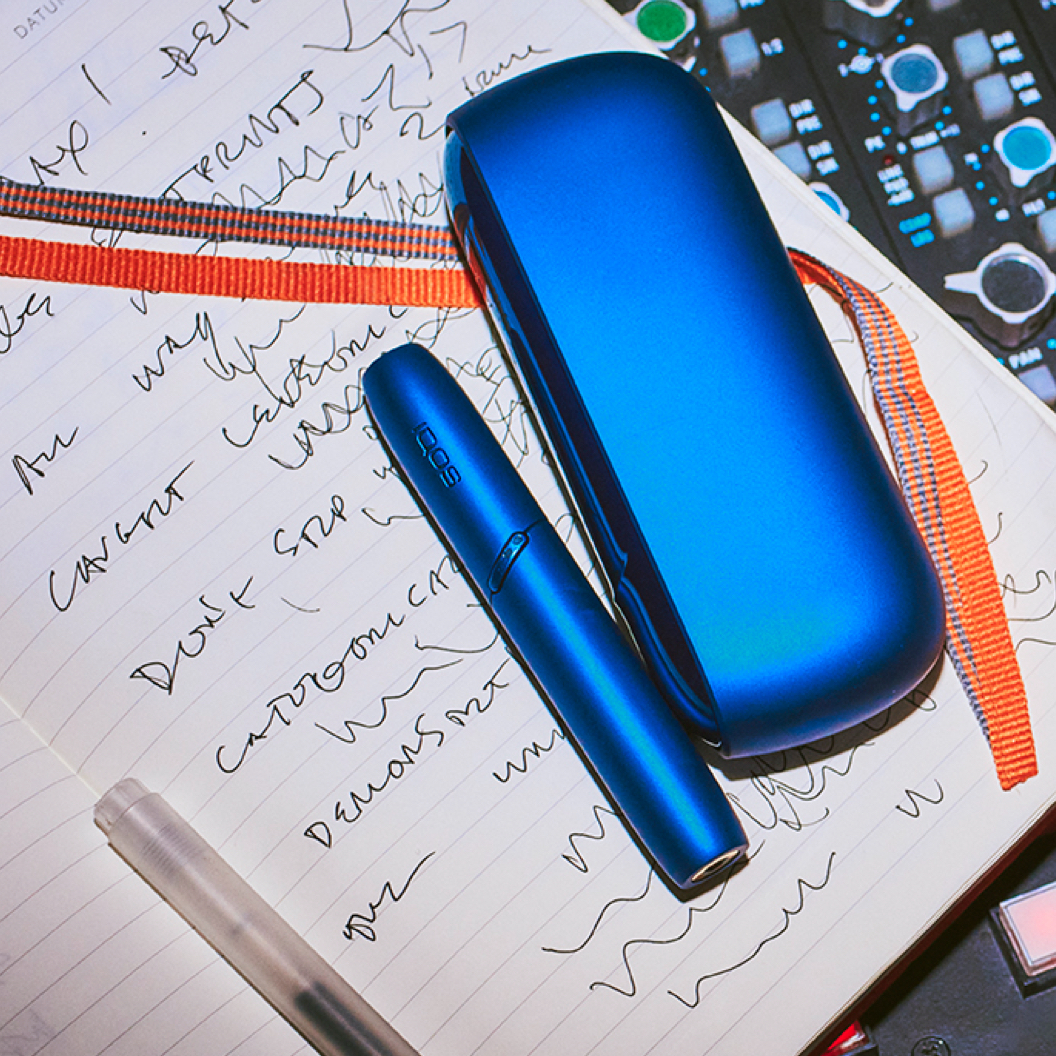 Stellar blue IQOS holder and charger on a note book